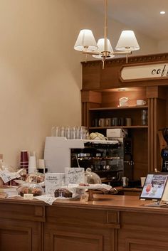 a coffee shop with lots of items on the counter and in front of it is a light fixture