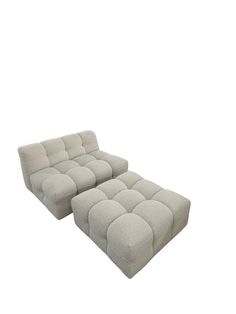 a white couch and ottoman sitting next to each other on a white background with no one in it