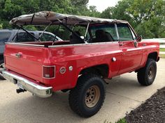 a red pick up truck parked in a parking lot