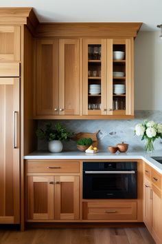 a kitchen with wooden cabinets and white counter tops