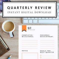 a desk with a keyboard, mouse and coffee on it that says quartery review instant digital download