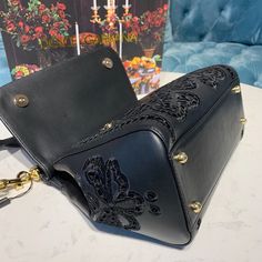 Dolce & Gabbana Medium Sicily Bag In Embroidered Black For Women 10.2in/26cm DG Rep 1:1 Size: 21 x 26 x 12 cm / 8.3 x 10.2 x 4.7 inches (Length x Height x Width) Laser-etched enameled metal plate with logo on the front Top handle and adjustable, detachable strap Storage pocket with zipper featuring a branded slider Metal feet studs on the base Item comes with a branded dust bag Includes dust bag. This product is of the best quality. Sicily Bag, Louis Vuitton Shirt, Soft Bag, Loafer Mules, Evening Clutch Bag, Metal Plate, Girls Bags, Tote Backpack, Sicily