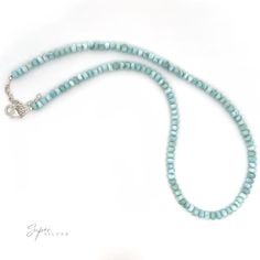 Immerse yourself in the serene beauty of the Caribbean with our stunning Larimar Beaded Necklace. Each bead captures the mesmerizing hues of the sea, making this piece chic enough to wear alone and stunning enough to showcase your favorite pendant. Larimar, known as the "Stone of Atlantis," is a rare gem that exudes tranquility and dazzle, infusing you with the soothing essence of the ocean. Whether you're dressing up for a special occasion or adding a touch of elegance to your everyday look, this necklace will elevate your style and transport you to the enchanting shores of the Caribbean. Embrace the colors of the sea and let your inner radiance shine with this exquisite piece. Materials: .925 Sterling Silver, Larimar Dimensions: 5mm, adjustable 18.5in-21in long Turquoise Aquamarine Round Bead Necklaces, Ocean-inspired Turquoise Necklaces With Round Beads, Ocean-inspired Turquoise Necklace With Round Beads, Ocean-inspired Turquoise Round Beads Necklace, Larimar Gemstone Bead Necklaces For Gifts, Larimar Gemstone Beads Necklace As Gift, Larimar Gemstone Beads Necklace For Gift, Rare Gems, Opal Earrings