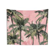 a pink wall hanging with palm trees on it