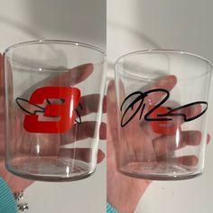 two glasses with handwritten letters on them are being held by someone's hands