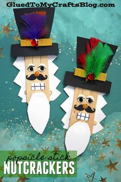 two nutcrackers made out of toilet paper on top of blue and green background