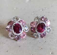 A Statement Earring handcrafted in Rose Gold Plated over Sterling Silver features a center Garnet embellished with Multi-color Spinel and Tourmaline and Halo Diamonds. A stunning, jaw-dropping stud earrings that makes a commanding statement earrings.(e-c-63) Earring measure 9mm x 20mm *LIKE* us on Facebook http://www.facebook.com/Belesas to get 10%off coupon code, *FOLLOW* us on Twitter https://twitter.com/#!/Belesas to get more exclusive coupon codes *All item are ready to ship! Free shipping o Luxury Pink Multi-stone Earrings, Pink Oval Ruby Earrings, Pink Multi-stone Earrings Fine Jewelry, Pink Multi-stone Earrings In Fine Jewelry Style, Pink Gemstones In Fine Jewelry Style, Pink Stone Earrings Gift, Pink Stone Earrings For Gift, Pink Natural Stones Wedding Earrings, Wedding Pink Earrings With Natural Stones