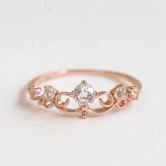 A romantic and feminine princess ring with delicate details, perfect gift for your little princess! Stone: Nature white Topaz in 4mm & 2.2mm. Bandwidth: 1.1mm Metal: 14k rose gold plated sterling silver base Crown Ring Princess, Aesthetic Rings, Tiara Ring, Princess Ring, Crown Ring, Birthday Ring, Ring Rose Gold, Delicate Details, White Topaz