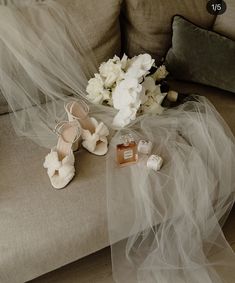 the bride's shoes are left on the couch with her veil draped over them