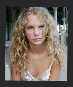 a woman with long blonde hair and blue eyes