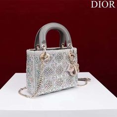 Features: Gray Smooth Calfskin and Satin with Bead Embroidery Reference: M0531ORKW_M932 The Lady Dior bag epitomizes Dior’s vision of elegance and beauty. It demonstrates the House’s unique leather craftsmanship and is offered in gray satin, embroidered with a multitude of beads in a hallmark Cannage-motif design, while the handles are crafted in tonal smooth calfskin. The pale gold-finish metal ‘D.I.O.R.’ charms are adorned with white crystals and further embellish its silhouette. The small style, with its thin, removable leather shoulder strap, can be carried by hand or crossbody. Thin, removable and adjustable leather shoulder strap Interior zip pocket The bag may be paired with different embroidered straps Dust bag included Dimensions: 20 x 17 x 8 cm / 8 x 6.5 x 3 inches Christian Dior Bag, Small Lady, White Crystals, Motif Design, Lady Dior Bag, Lady Dior, Beaded Embroidery, Dior Bag, Wallet Case