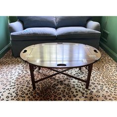 A butler's tray-top coffee table with an open-handled tray with fold down sides and ends resting on a fixed rectangular base with cross stretchers and square legs   Product Information: Materials: Mahogany  Dimensions: 40” W x 31” D x 17” H.   Style: Campaign  Condition: Very good vintage condition. Surface wear consistent with age and use. Structurally sound.  Shipping: $350  About Us: We curate antique, vintage and high-end, gently-used home furnishings sourced from some of the most coveted and stylish estates on the East Coast. We rent and sell. We ship with care and guarantee safe delivery. Tray Top Coffee Table, Drop Leaf Coffee Table, Leaf Coffee Table, Wabi Sabi Coffee Table, Triangle Coffee Table, Butler Tray, Rattan Coffee Table, Brass Coffee Table, Coffee Table Vintage