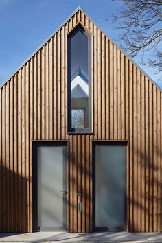 a wooden building with two doors and windows