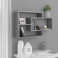 a white shelf with books and other items on it