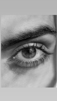 a man's eye with long eyelashes