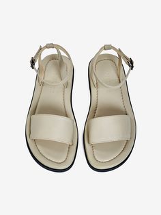 Editor's NoteNeute designs shoes with the natural luxury of leather.- Classic and daily sandals- Sophisticated stitch line detail- Comfortable and stable fit with buckle strap- Soft and smooth goat skin used Measurements (in.)- Size: KR 220MM - KR 260MM (35 - 39)- Heel Height: 0.98 in. Composition & Care- Upper: Goat Skin, Lining: Pig Skin, Sole: Suede Sole- All products are hand-made, so sewing and finishing may not be uniform, and double stitching, fine pen marks, and removable b Beige Leather Slingback Sandals With Round Toe, Leather Flat Heel Slingback Sandals With Adjustable Strap, Beige Leather Footbed Sandals With Round Toe, Beige Sandals With Buckle Closure And Single Toe Strap, Cream Ankle Strap Sandals With Buckle Closure, Modern Beige Sandals With Buckle Closure, Cream Closed Toe Sandals With Leather Footbed, Cream Leather Sandals With Adjustable Strap, Classic Beige Sandals With Buckle Closure