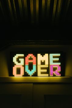 a neon sign that says game over on it