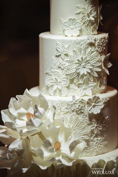 a wedding cake with white flowers on top