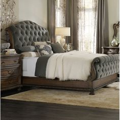 a bedroom with a bed, dressers and mirror in it's center area