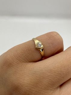 This cute 14K gold heart signet ring with a center stone is the perfect size for a baby, child, or pinky ring for women. The center stone is a simulated pink or white diamond (Cubic Zirconia). The ring is made of 100% 14K gold. It's a beautiful ring for a little girl or a gorgeous pinky ring.  Ring pictured on woman's 2 1/2 pinky finger    * 14K Solid Gold * High Quality Cubic Zirconia Stone * Small sized Ring ▬ All jewelry pieces are sent in a gift box  ▬ Our shipping and return policies: ~ Ite Women’s Pinky Rings, Heart Pinky Ring, Dainty Pinky Ring, Womens Pinky Ring, Small Gold Rings, Pinky Signet Ring Women, Gold Pinky Ring Women, Little Finger Rings For Women, Pinkie Rings For Women