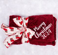 a red and white christmas towel with a bow on it