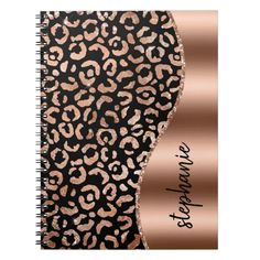 a spiral notebook with leopard print and rose gold foil