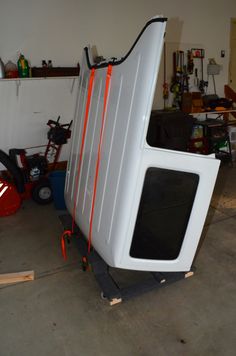 a white microwave oven sitting in a garage