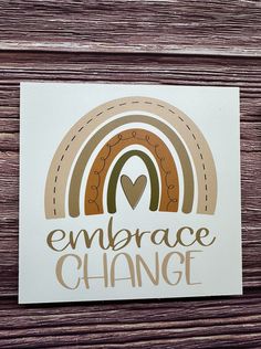 a sticker that says embrace change with a rainbow in the center and a heart at the bottom