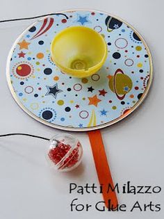 a plate with a bowl on it and some candy in front of it, along with the words patti mizzo for glue arts