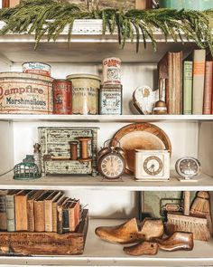 an old fashioned shelf with books and other items