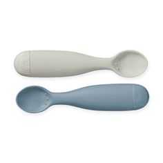 two spoons sitting next to each other on a white surface