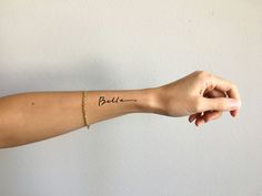 a woman's arm with the word budi written in cursive writing on it