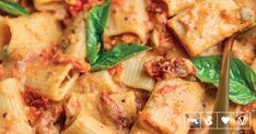 a close up of a plate of pasta with basil