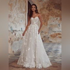 a woman in a wedding dress posing for the camera