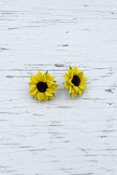 "Charm sunflower earrings for every lovely day. The life of the real sunflowers is too short to make some flower earrings with them. Instead of real flowers, I offer you these beautiful handmade flowers that will never fade. Such a piece of floral jewelry can please you for many years. They will beautifully adorn your look in any season of the year. Details: * Designed with handmade flowers out of cold porcelain (air dry clay); * Diameter of the flowers is about 1\" (2.5cm); * Base color will be Yellow Sunflower Design Earrings As Gift, Yellow Sunflower Design Flower Earrings As Gift, Yellow Flower Shaped Jewelry With Sunflower Print, Yellow Flower-shaped Jewelry With Sunflower Print, Yellow Birth Flower Earrings, Handmade Yellow Flower Earrings, Yellow Flower Earrings With Birth Flower Detail, Yellow Hypoallergenic Flower Earrings, Yellow Sunflower Design Flower Earrings