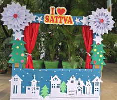 an outdoor stage decorated with paper flowers and decorations