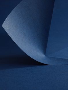 the corner of a blue cloth is shown in close up, as if it were folded or folded