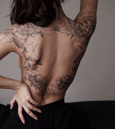 the back of a woman with tattoos on her body