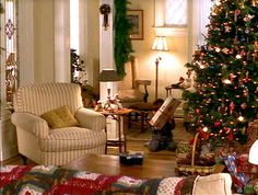 a living room with a christmas tree in the corner