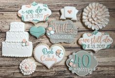 wedding cookies are arranged on a wooden table with the names of their guests and date