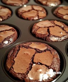 chocolate cupcakes with frosting in a muffin tin