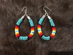 Authentic Beautiful Native American Indian Jewelry Navajo Zuni Hand Beaded  2 3/8inch Hoop Earrings Handcrafted by Navajo Artist Harriet Crosby Great for a  Gift❤️ Present in virtually every Native American tribe, the feather symbol is universally recognized as a representation of trust, strength, wisdom, freedom, and honor. Incorporated into many sacred pieces of Native American wear, the feather is easily one of the most respected symbols. Southwestern Style Beaded Earrings, Southwestern Style Beaded Dangle Hoop Earrings, Southwestern Teardrop Jewelry With Colorful Beads, Southwestern Style Earrings With Colorful Beads, Southwestern Style Beaded Earrings For Festival, Southwestern Teardrop Beaded Earrings, Southwestern Multicolor Teardrop Beaded Earrings, Adjustable Southwestern Beaded Earrings, Southwestern Multicolor Beaded Earrings