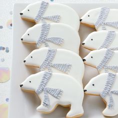 decorated cookies in the shape of polar bears on a plate