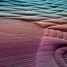 a close up view of a quilted bed spread