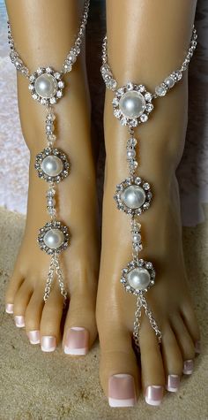 This beautiful pair of barefoot sandals features  a  silver linked chain with three round half pearl charms that are carressed with rhinestones. Pearl, crystal and silver beads link the charms  that adorn the top of the foot. and around the ankle. Each piece detaches at the back of the ankle with a lobster claw latch. They are size adjustable and one size fits most. Comfortable and versatile, they will lend themselves to casual or formal events.  All items are made in a smoke free environment. *If there is any issue with your order, please let me know so that I can correct it. Thanks for visiting my shop!👣 Elegant Silver Anklets For The Beach, Elegant Silver Toe Ring Barefoot Sandals, Elegant Pearl Beaded Anklets, Elegant Silver Beaded Barefoot Sandals, Elegant Pearl Anklets For Party, Elegant Pearl Chain Anklets For Wedding, Elegant Wedding Anklets With Pearl Chain, Elegant Wedding Pearl Chain Anklets, Adjustable Silver Barefoot Sandals For Wedding