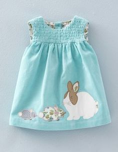 a blue dress with a bunny and fish on it