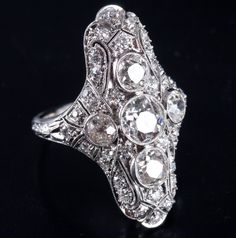 Vintage 1900s Platinum J SI1 Old European Diamond Filigree Cocktail Ring 2.19ctwMetal Information: .950 PlatinumTotal Weight: 5.56gBand Width: 1.65mmSize: 3.75Circa: 1900'sStone InformationMain StoneGem Type: DiamondShape: Old European (5.5mm)Color: JClarity/Quality: SI1Carat Weight: .65ctNumber of Stones: 1Accent StonesGem Type: DiamondShape: Oval (5mm x 4mm)Color: JClarity/Quality: SI1Carat Weight: .33ctNumber of Stones: 2Accent StonesGem Type: DiamondShape: Old European (3.7mm)Color: JClarity Alternative Wedding Dresses, Alternative Wedding, Cocktail Ring, Cocktail Rings, Beautiful Fashion, Beautiful Jewelry, Vintage Jewelry, Platinum, Wedding Dresses