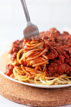 spaghetti with meat and sauce on a white plate