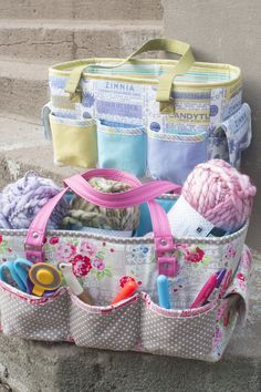 a bag filled with lots of crafting supplies sitting on top of a stone step