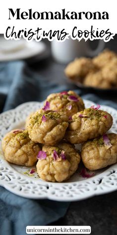 a white plate topped with cookies covered in sprinkles on top of a table